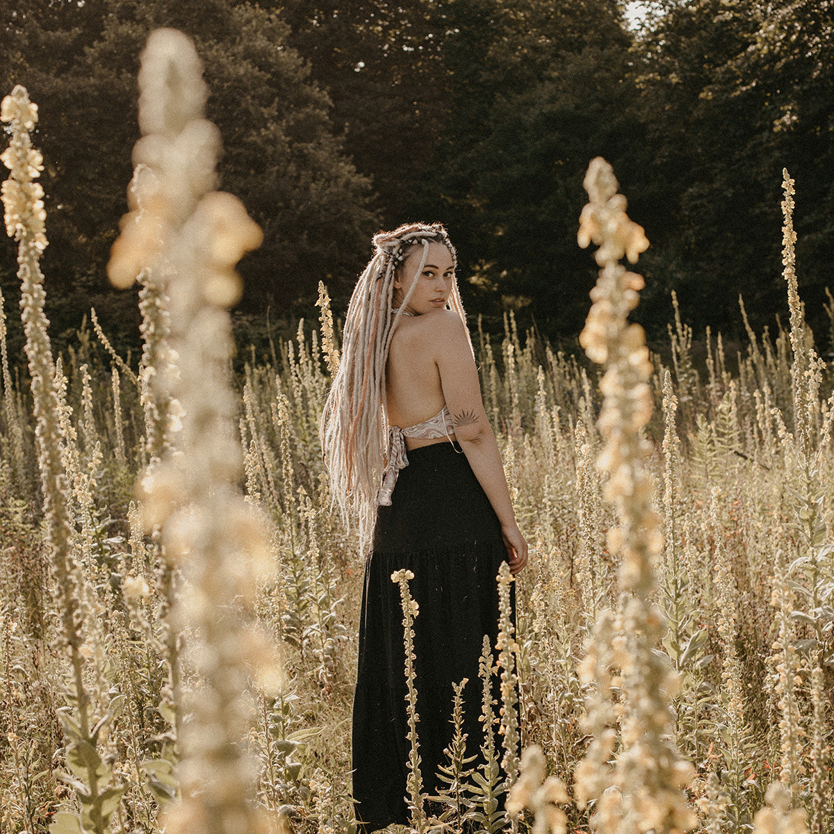 Summer dreadlocks, Romy in a field of flowers, How do you care for dreads in summer