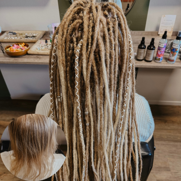 Dreadshop Salon customer with long braided dreadlock extensions in blonde colors and with decorations
