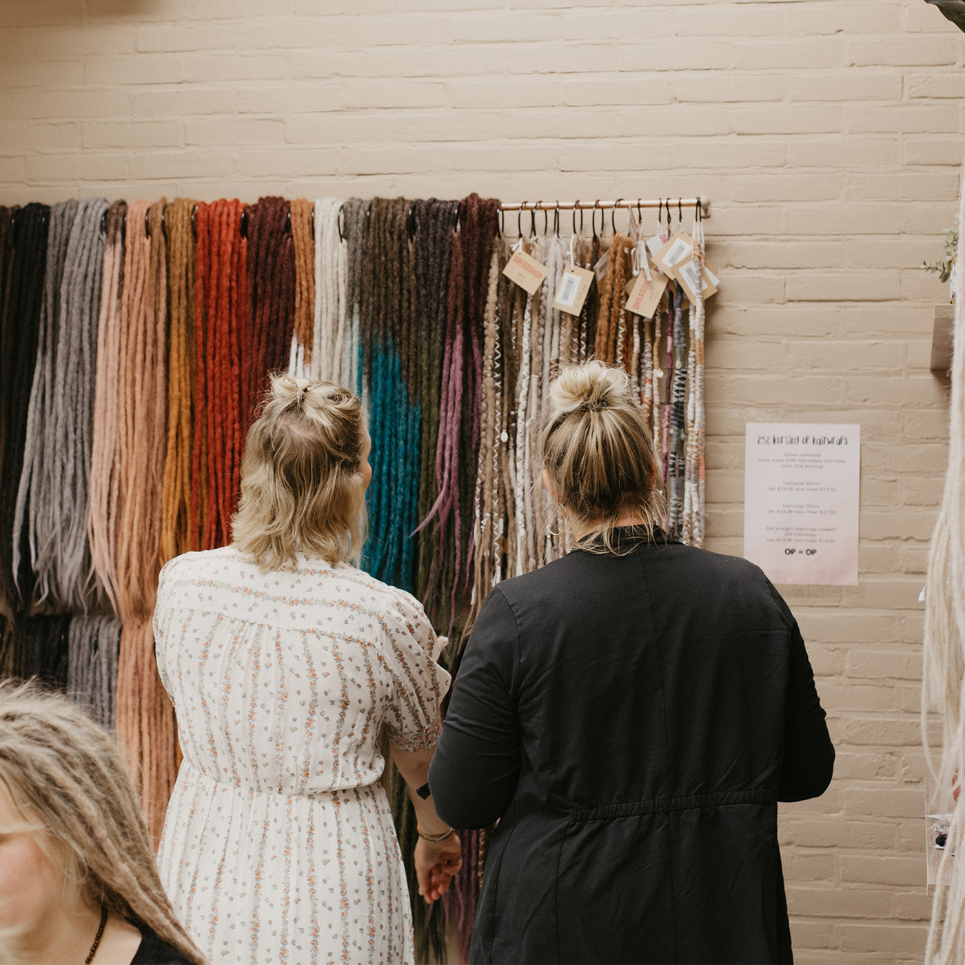 Renate and a client looking at the rack of locks of love colors