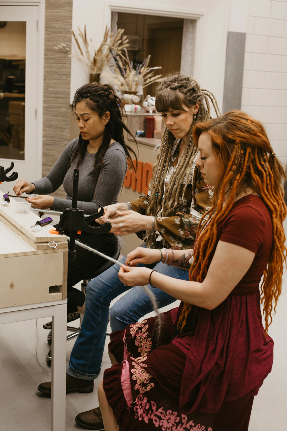 Diane teaching out Dreadshop students how to create their own locks of love