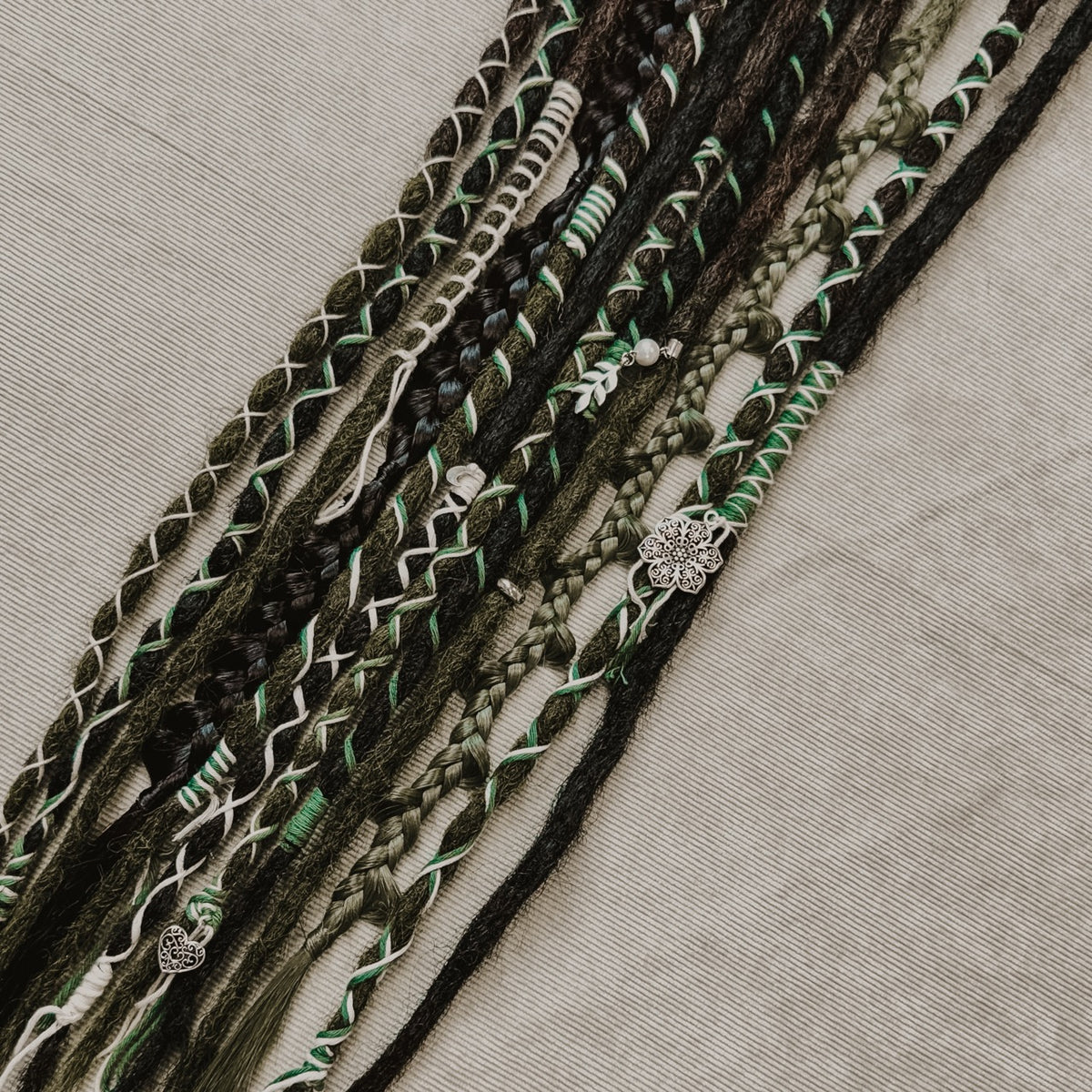 Decorated Dreadlock Extensions: black and green mix, ombre dreads with decorations. Accent Set from Dreadshop.