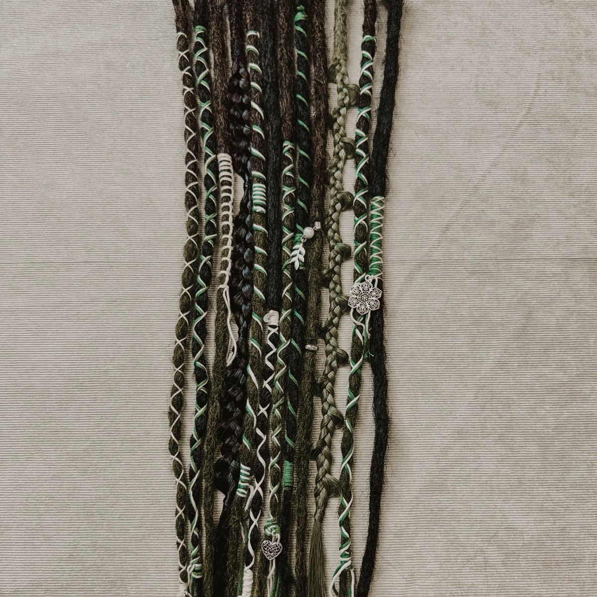 Decorated Dreadlock Extensions: black and mossy mix, ombre dreads with decorations. Accent Set from Dreadshop.