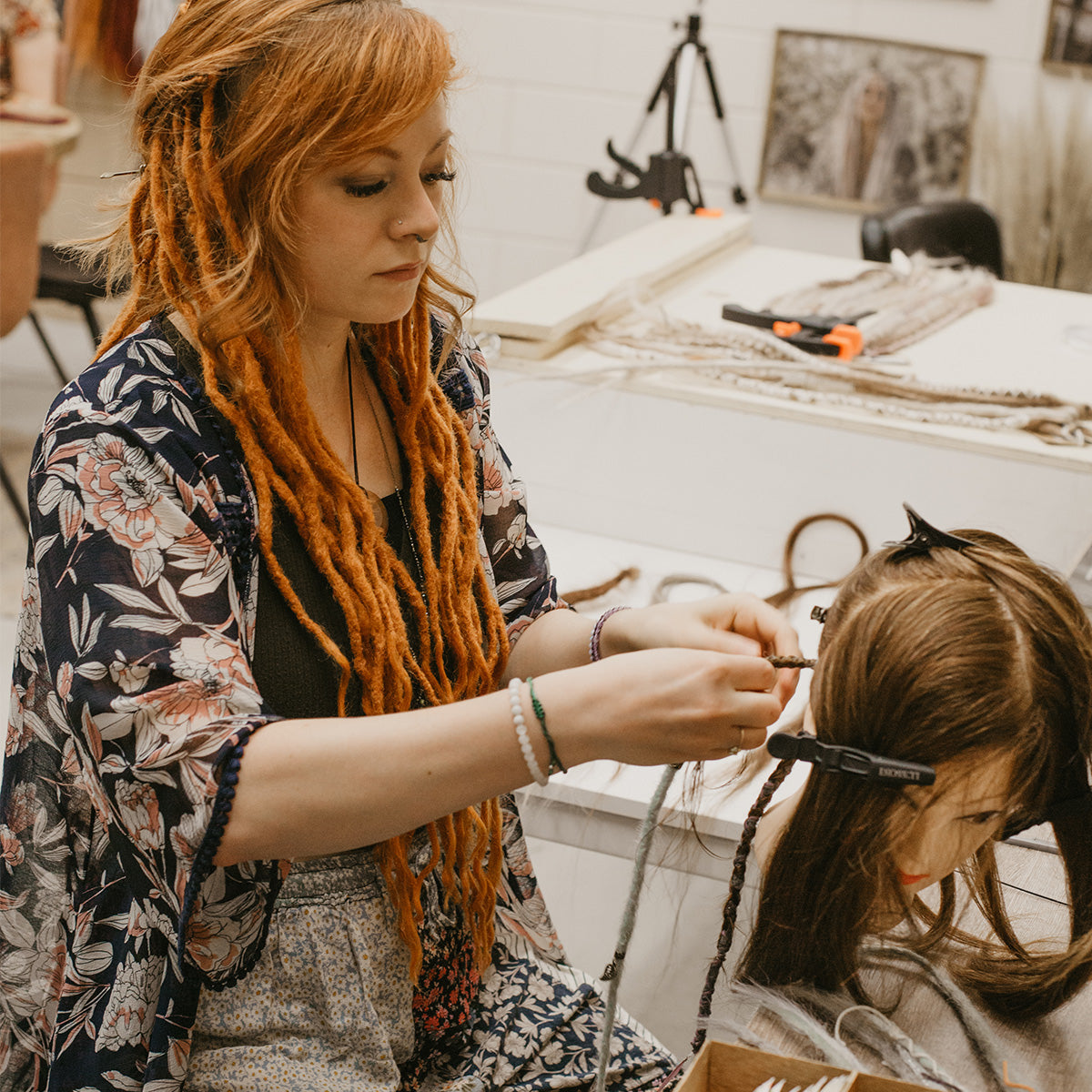 Online course, Jordan our student braiding in Synthetic dreadlock extensions on Dolly