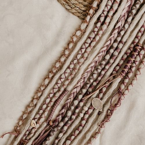 Decorated Dreadlock Extensions: ash blonde, white purple, plum decorations. Accent Set from Dreadshop. Close up on the middle