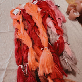 Pink tones Synthetic Hair Braids in Bulk. Henlon Hair braids from Dreadshop warehouse, tangled and fluffy. 