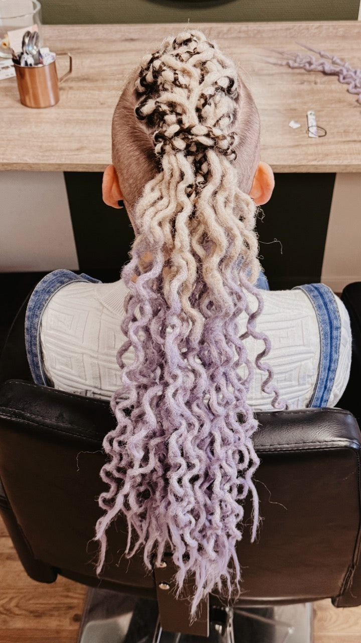 Dreadshop Salon customer with curly partial dreadlock extensions in ombre whiteand purple colors with shaved sides