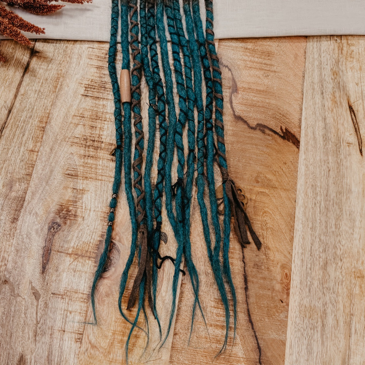 Blue turquoise brown Decorated Set of Dreadlock Extensions. Great for Partial style or to be added to real Dreads. Picture is showing the ends of the set with close up on decorations, beads and yarn in brown tones.