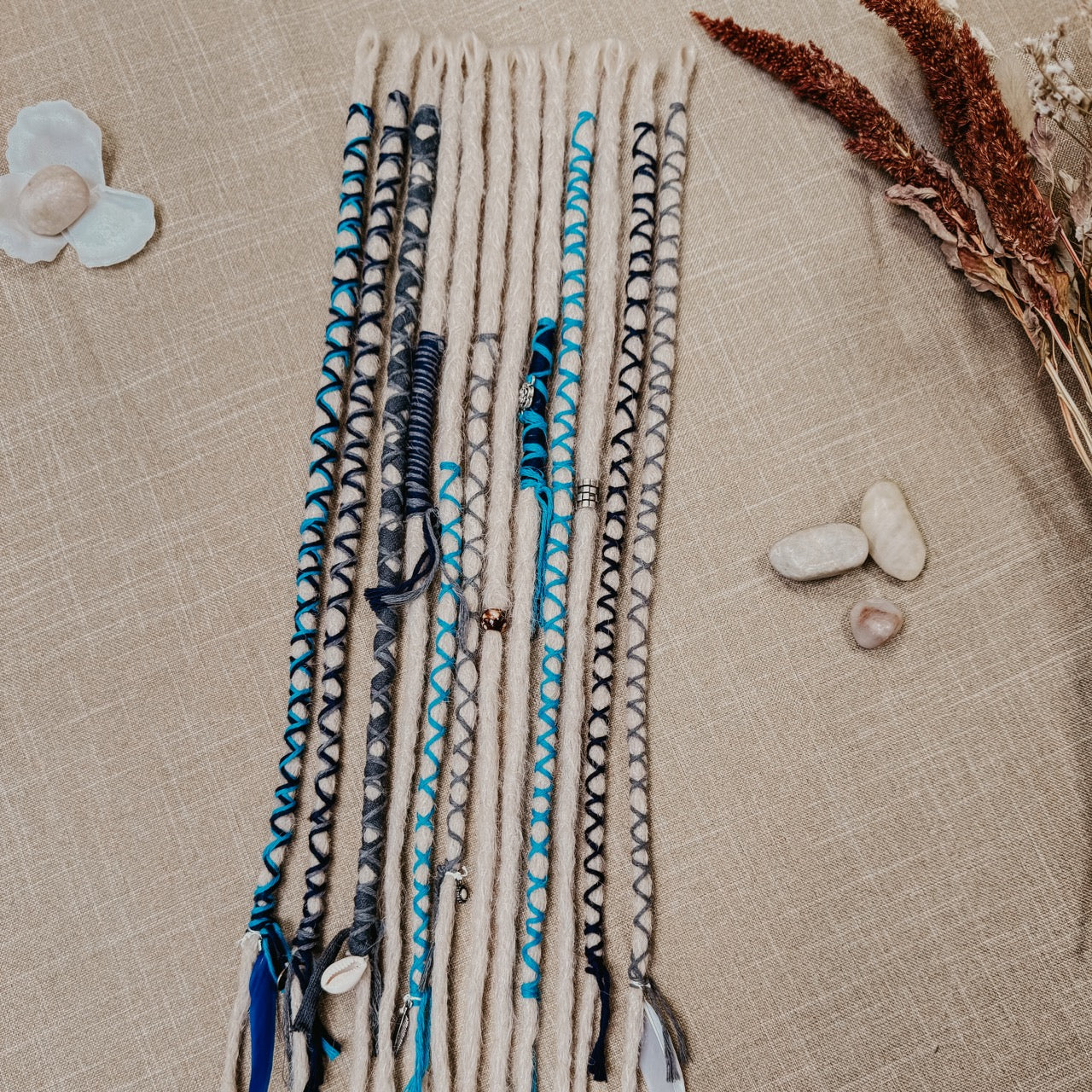 Decorated Dreadlock Extensions: ash blonde, white silver dreads with blue and gray decorations. Accent Set from Dreadshop. 