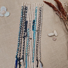 Decorated Dreadlock Extensions: ash blonde, white silver dreads with blue and gray decorations. Accent Set from Dreadshop. 