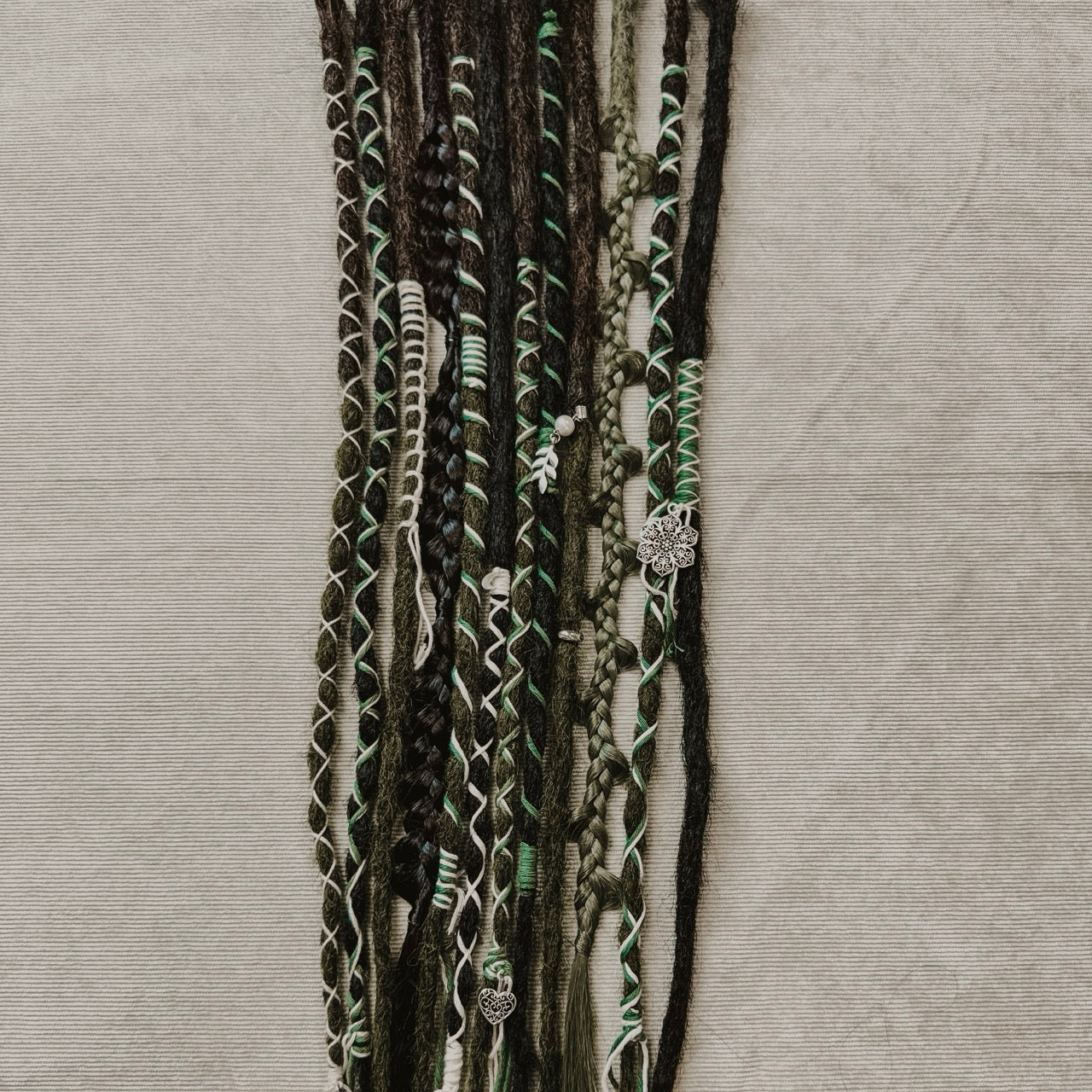 Decorated Dreadlock Extensions: black and mossy mix, ombre dreads with decorations. Accent Set from Dreadshop. 