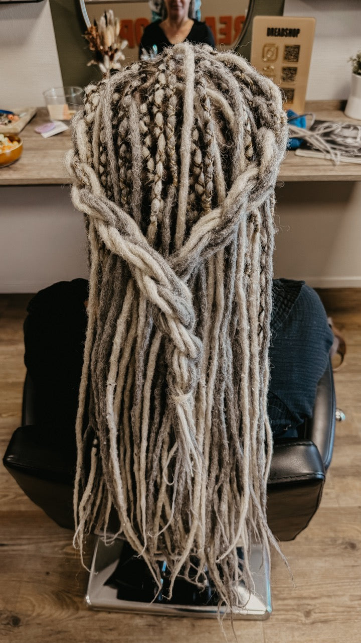 Back view of a customer from Dreadshop Salon with Gray and White Dreadlock Extensions installed | Locks of Love 