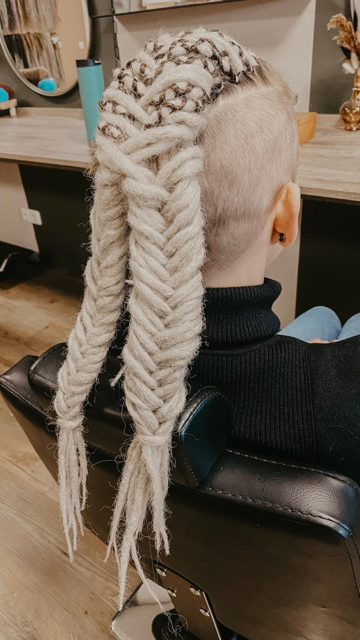 Dreadshop Salon customer with partial dreadlock extensions in white color with shaved sides