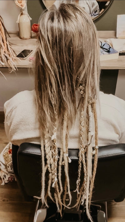 Partially braided dreadlock extensions. Dreadshop Salon customer. Short hair with long decorated dreadlocks
