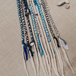 Decorated Dreadlock Extensions: ash blonde, white silver dreads with blue and gray decorations. Accent Set from Dreadshop. CLose up on the ends