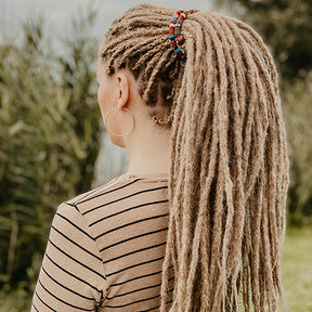 Renate from the back, wearing her dreads in a spiralock. she is wearing the dreadset Thin Dark blonde  in Bum  length, Dreadset Locks of Love Shop the look, dreadset full head, Dreadset thin locks of love 